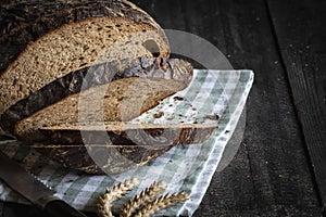 Sliced brown bread fresh baked on a kitchen towel