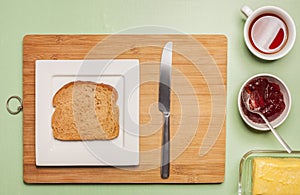 Sliced brown bread on square plate with herbal tea