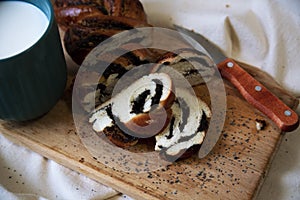 Sliced bun with poppy seeds on a wooden Board