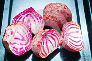 Sliced Candy Cane Beets, also known as Chioggia Beets, arranged on a baking tray.