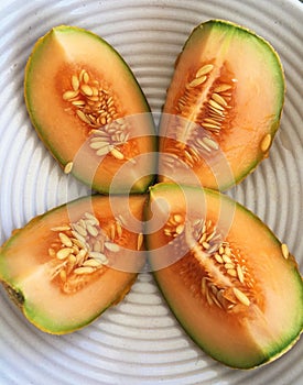 Sliced Cantaloupe Melon in Modern White Bowl