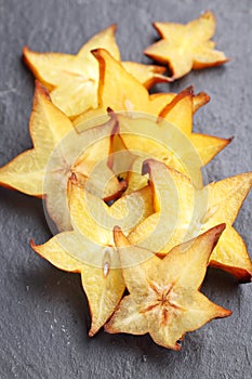 Sliced carambola, or starfruit, on a slate surface