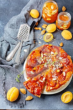 Sliced caramelized tarte tatin pie with apricots