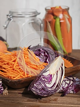 Sliced carrots and red cabbage on a wooden dish. Harvesting products. Kitchen. Fermented, canned vegetarian food. The concept of