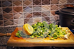 Sliced celery leaves and lemon