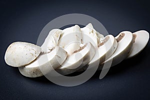 Sliced champignon on a dark background