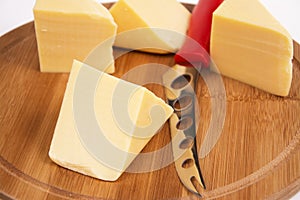 Sliced cheese on the board in the kitchen.