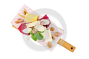 Sliced Cheese with walnuts and grapes on cutting board on isolated background