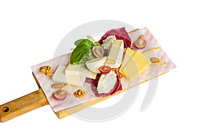 Sliced Cheese with walnuts and grapes on cutting board on isolated background