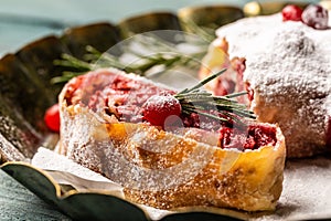 Sliced cherry strudel with cranberries and walnut. Food recipe background