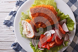 Sliced Chicken cordon bleu and salad close-up. Horizontal top vi