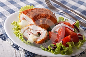 sliced Chicken cordon bleu schnitzel and salad closeup. horizontal