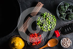 Sliced chili, frozen peas in a bowl of buckwheat noodles