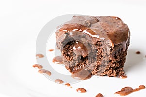 Sliced chocolate cup cake muffing with topping melting chocolate cream above white marble background