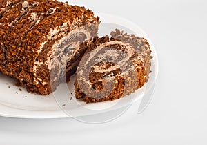 Sliced chocolate roll on white dish