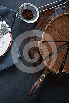 Sliced chocolate tort on dark background