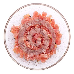 Sliced and chopped tuna fillet in glass bowl isolated on white background