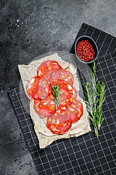 Sliced chorizo salami. Spanish traditional chorizo sausage. Black background. Top view