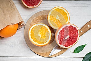 Sliced citrus fruits on a table, orange and grapefruit