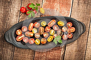 Sliced colorful cherry tomatoes with oil and spice
