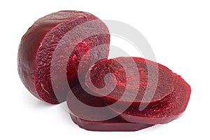 Sliced cooked beetroot on white.