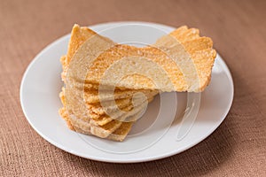Sliced crispy bread in white ceramic dish.