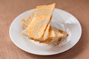 Sliced crispy bread in white ceramic dish.