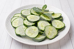 Sliced cucumber with mint on a plate. concept diet