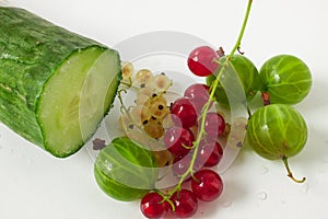 Sliced cucumber with red currants and green gooseberries