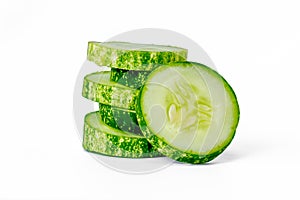 Sliced cucumbers for fresh vegetables, in a stacked composition, isolated on a white background