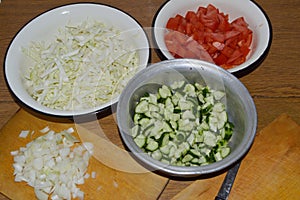 Sliced cucumbers, tomatoes and onions for homemade preparation