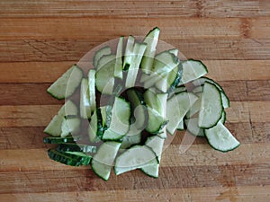 Sliced cucumbers on wooden background. Sliced cucumbers on a cutting board.