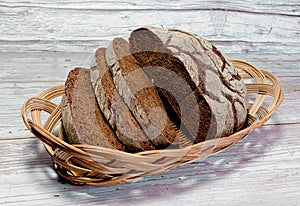 Sliced dark bread in a wicker basket