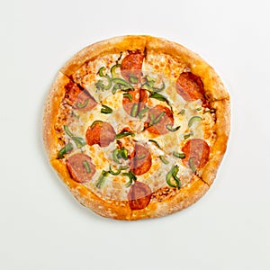 Sliced delicious fresh pizza with pepperoni and cheese on a white plate. Top view with copy space for text. Flat lay