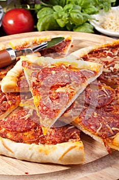 Sliced delicious pepperoni pizza and ingredients