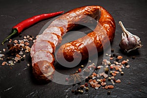 Sliced dry-cured smoked ham sausage with garlic and chili
