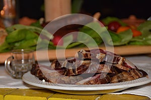 Sliced drying pork meat on decorated table domestic style in Balkan