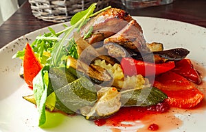 Sliced duck fillet in red berry sauce, salad, bell pepper, zucchini, mashed potatoes