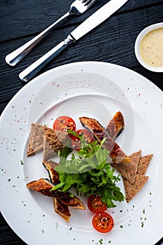 Sliced eel in flavored soy sauce glaze.