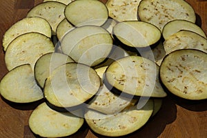 sliced eggplant in heart shape on wooden background