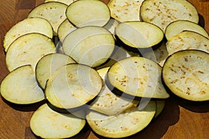 sliced eggplant in heart shape on wooden background