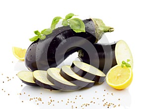 Sliced eggplants basil leaves,lemons,black pepper isolated white
