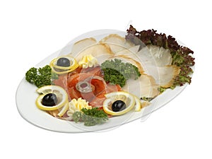 Sliced fish assortment with herds and lemon on white oval plate isolated