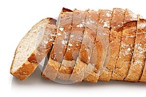 Sliced floury wheat bread on white background