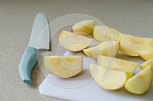 Sliced fresh apple, kitchen knife on side, summer fruit from market