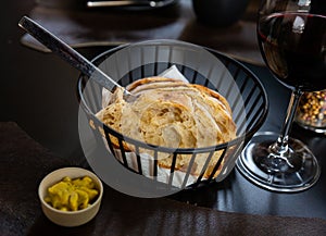 Sliced fresh baked artisan bread with butter in serving basket