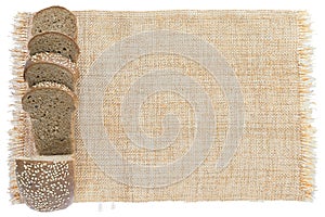 Sliced fresh bread on sackcloth isolated on white background