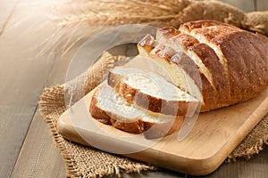 Sliced of fresh homemade french breads on wood background