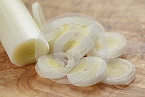 Sliced fresh leek on olive board