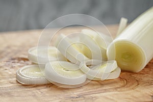 Sliced fresh leek on olive board